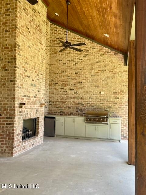 unfurnished living room featuring a fireplace, high vaulted ceiling, ceiling fan, and wood ceiling