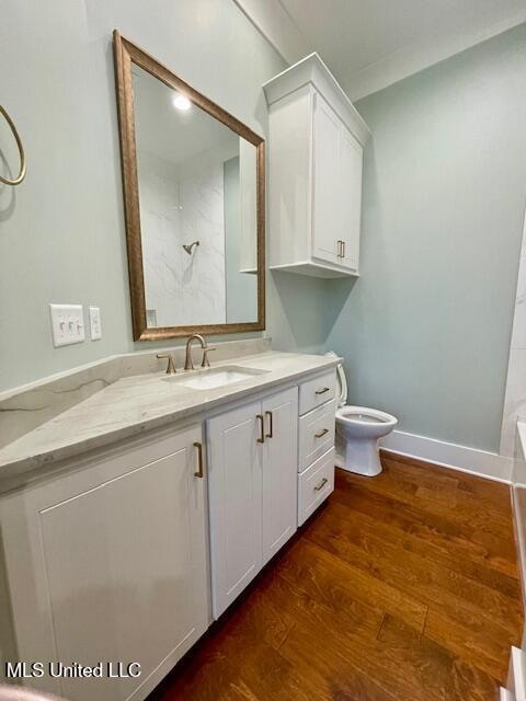 bathroom featuring walk in shower, vanity, wood-type flooring, and toilet