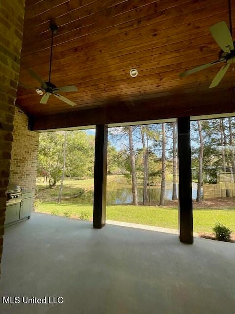 view of patio featuring ceiling fan and a water view