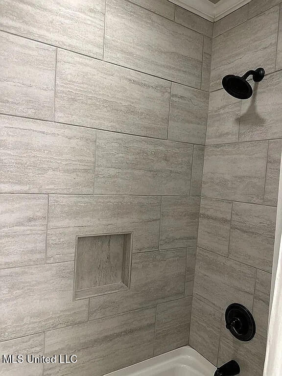 room details featuring shower / tub combination