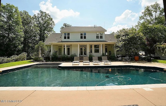 back of house featuring an outdoor pool, french doors, and a patio