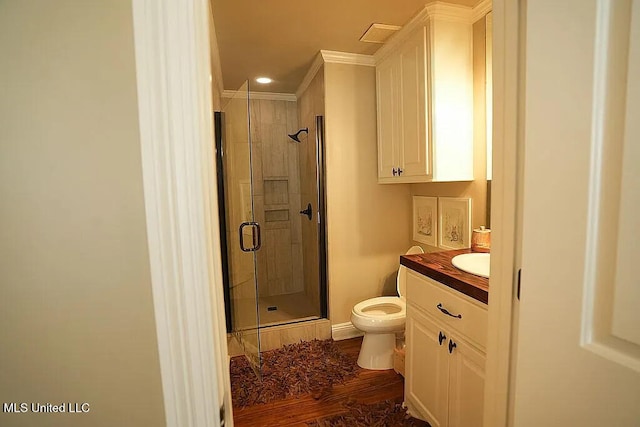 full bath with toilet, a shower stall, crown molding, and vanity