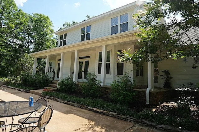 view of front of house with a porch and french doors