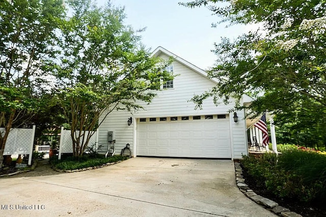 view of property exterior featuring concrete driveway