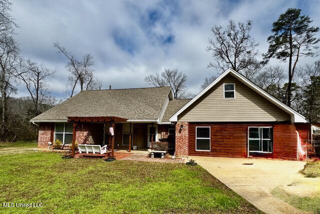 rear view of house with a yard