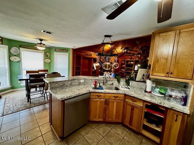 kitchen with visible vents, a sink, a peninsula, and stainless steel dishwasher