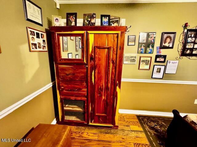 interior space featuring baseboards and wood finished floors