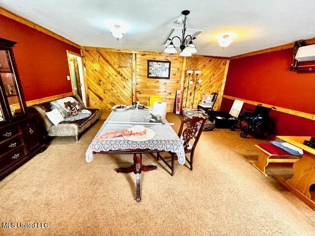 recreation room with carpet and wooden walls