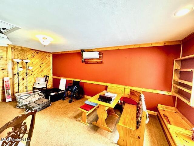 game room featuring carpet, wooden walls, and a wall mounted air conditioner