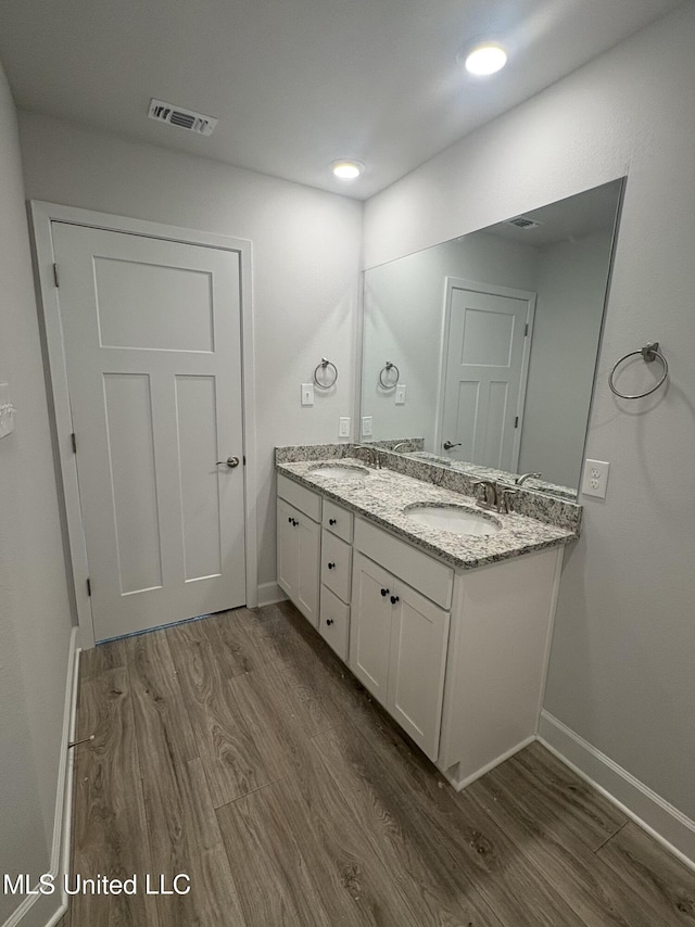 18059 Tiffany Renee Dr, Gulfport, MS 39503 - bathroom with wood finished floors, baseboards, double vanity, and recessed lighting