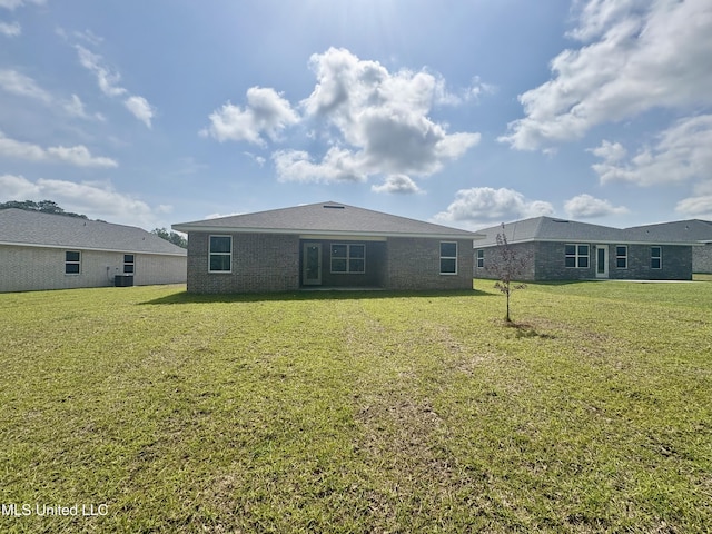 18059 Tiffany Renee Dr, Gulfport, MS 39503 - rear view of property featuring a yard and brick siding