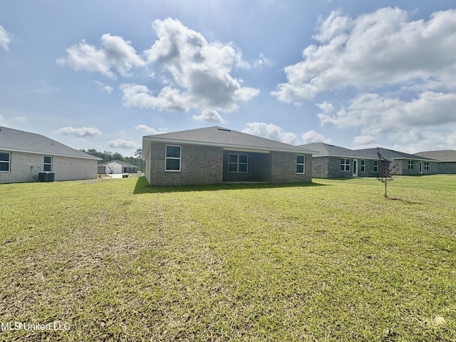 18059 Tiffany Renee Dr, Gulfport, MS 39503 - rear view of property with a yard, central air condition unit, and brick siding