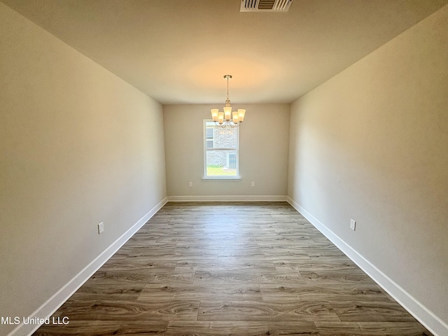 18059 Tiffany Renee Dr, Gulfport, MS 39503 - unfurnished room featuring a chandelier, dark wood-type flooring, and baseboards