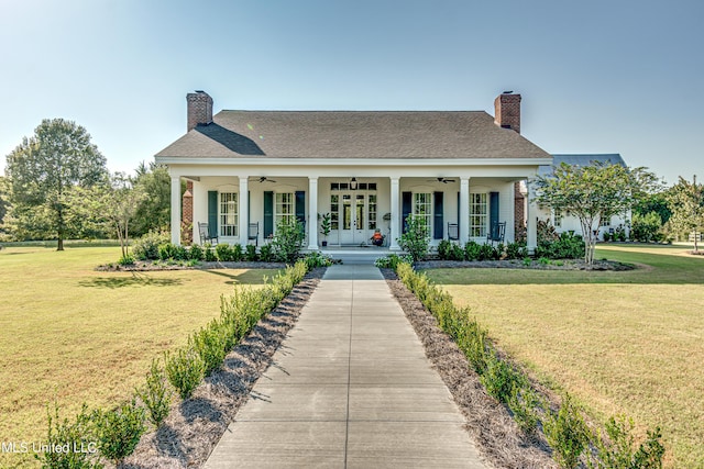 381 Parkinson Rd, Flora, MS 39071 - neoclassical home featuring ceiling fan, a front lawn, a porch, and a chimney