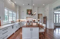 381 Parkinson Rd, Flora, MS 39071 - kitchen with dark wood finished floors, a center island, a kitchen breakfast bar, and recessed lighting
