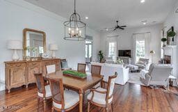 381 Parkinson Rd, Flora, MS 39071 - dining room featuring wood finished floors, recessed lighting, a chandelier, ceiling fan, and a fireplace