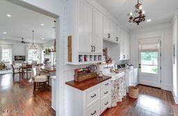 381 Parkinson Rd, Flora, MS 39071 - kitchen featuring a chandelier, dark wood-type flooring, white cabinets, recessed lighting, and pendant lighting