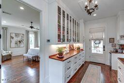 381 Parkinson Rd, Flora, MS 39071 - kitchen with dark wood-type flooring, glass insert cabinets, white cabinetry, and recessed lighting