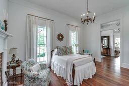 381 Parkinson Rd, Flora, MS 39071 - bedroom with wood finished floors and a chandelier