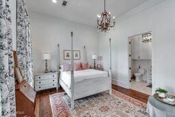 381 Parkinson Rd, Flora, MS 39071 - bedroom with a chandelier and wood finished floors