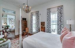 381 Parkinson Rd, Flora, MS 39071 - bedroom featuring a chandelier and wood finished floors