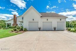 381 Parkinson Rd, Flora, MS 39071 - view of side of home with an attached garage and driveway