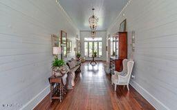 381 Parkinson Rd, Flora, MS 39071 - corridor with wood finished floors, baseboards, a chandelier, and ornamental molding