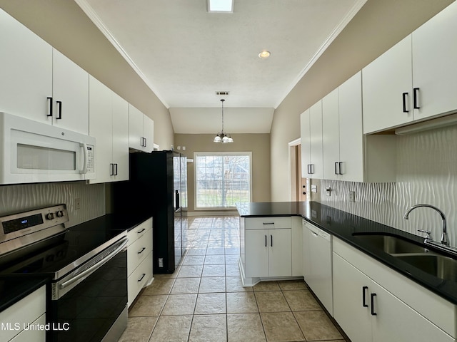 kitchen with white appliances, tasteful backsplash, white cabinetry, and sink