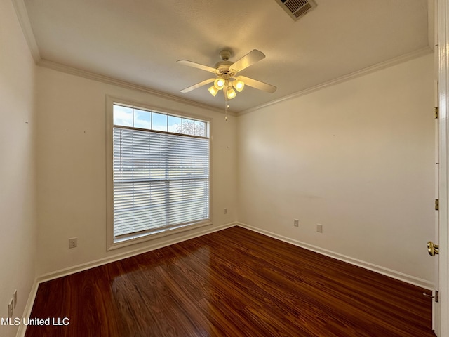 spare room featuring dark hardwood / wood-style flooring, ceiling fan, and crown molding