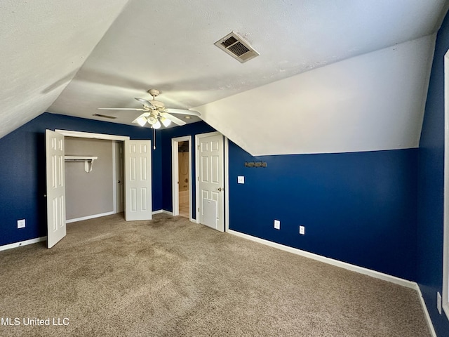 bonus room featuring carpet flooring, ceiling fan, a textured ceiling, and lofted ceiling