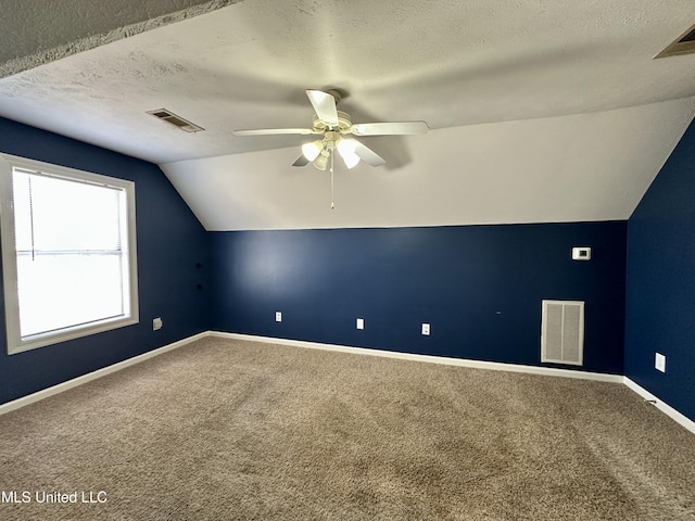 bonus room with ceiling fan, carpet floors, a textured ceiling, and vaulted ceiling