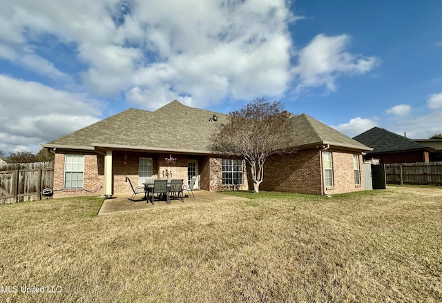 rear view of house with a lawn