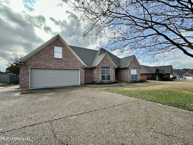 view of front facade with a garage and a front yard