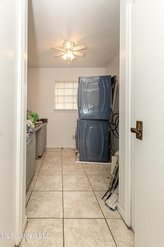 clothes washing area featuring ceiling fan, washer / clothes dryer, a textured ceiling, and light tile patterned floors