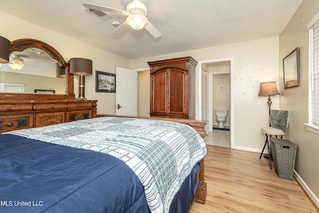 bedroom featuring light hardwood / wood-style floors, a textured ceiling, connected bathroom, and ceiling fan