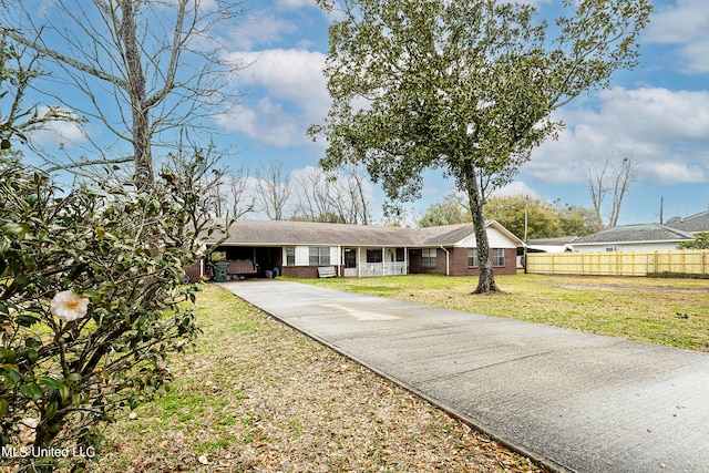 ranch-style home featuring a front yard