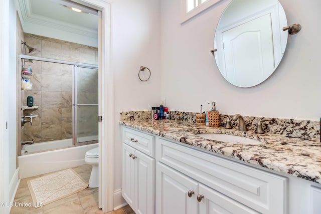 full bath featuring toilet, bath / shower combo with glass door, ornamental molding, and vanity