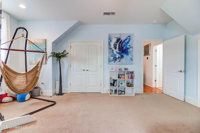 interior space with carpet, visible vents, and baseboards