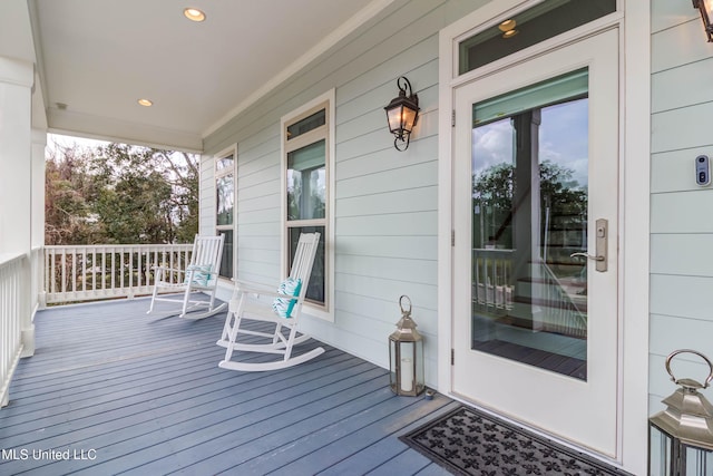 wooden terrace featuring covered porch