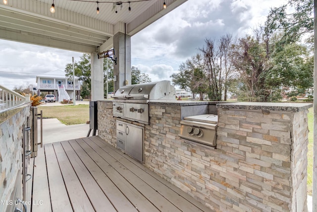 deck with area for grilling and a grill