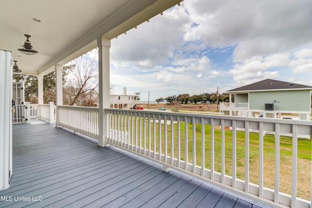 wooden deck featuring a lawn