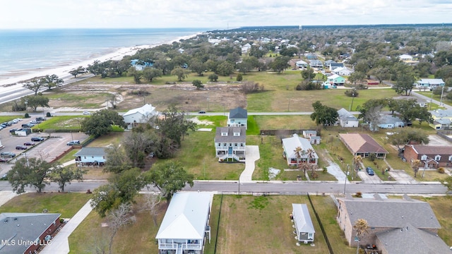 drone / aerial view featuring a water view, a residential view, and a view of the beach