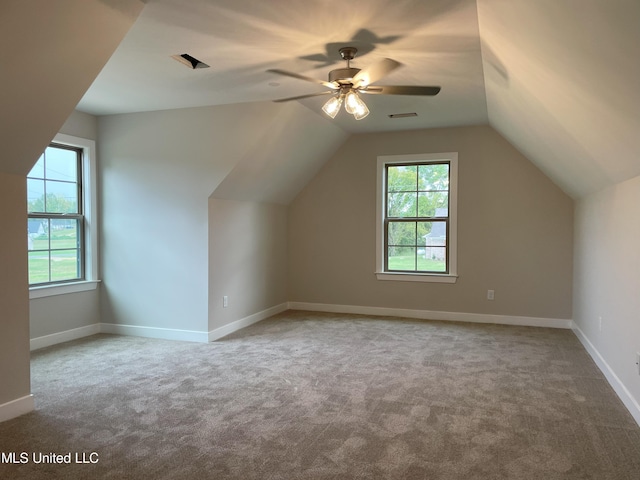 additional living space with light carpet, lofted ceiling, and ceiling fan