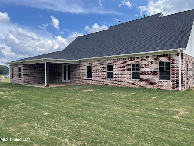 9092 Bennett Trl, Hernando, MS 38632 - back of house featuring brick siding, a lawn, a shingled roof, and a patio area