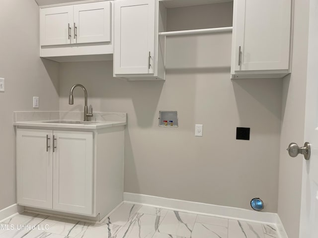 9092 Bennett Trl, Hernando, MS 38632 - laundry area featuring hookup for an electric dryer, light marble finish floors, hookup for a washing machine, and cabinet space