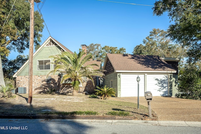 view of front of property with central AC and a garage