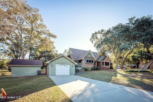 view of front facade with an outbuilding, a garage, and a front lawn