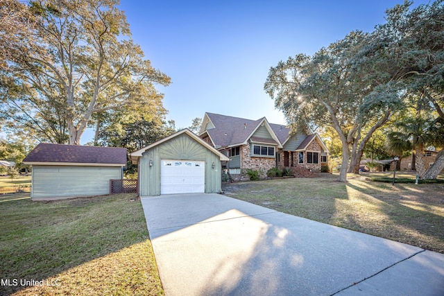 view of front facade featuring a garage, an outbuilding, and a front lawn