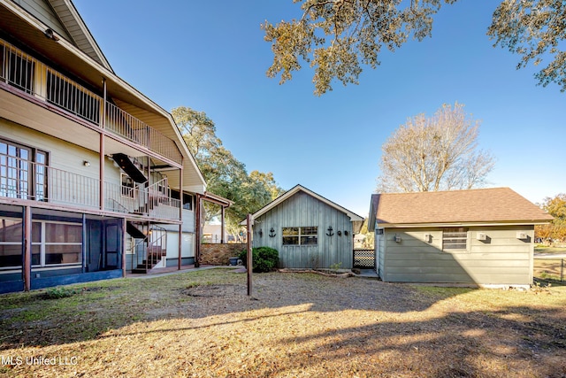 view of yard with a balcony and an outdoor structure