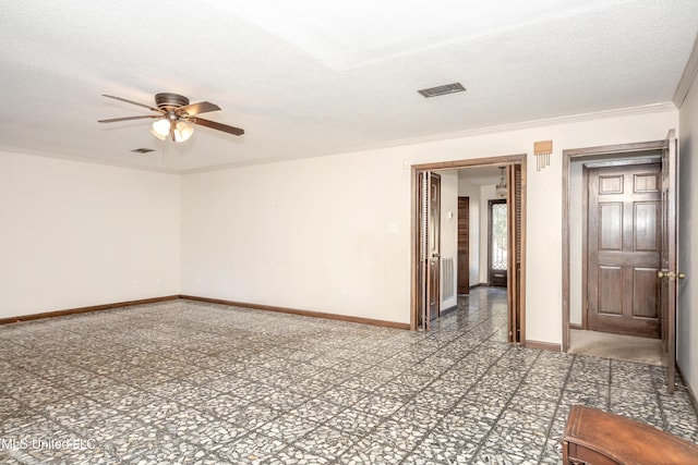 spare room with ceiling fan, a textured ceiling, and ornamental molding